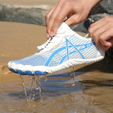 Elastic Lock Laces Mesh Breathable Hike Footwear being splashed with water on the beach.