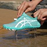 Elastic Lock Laces Mesh Breathable Hike Footwear being held over water, showcasing its water-friendly design.