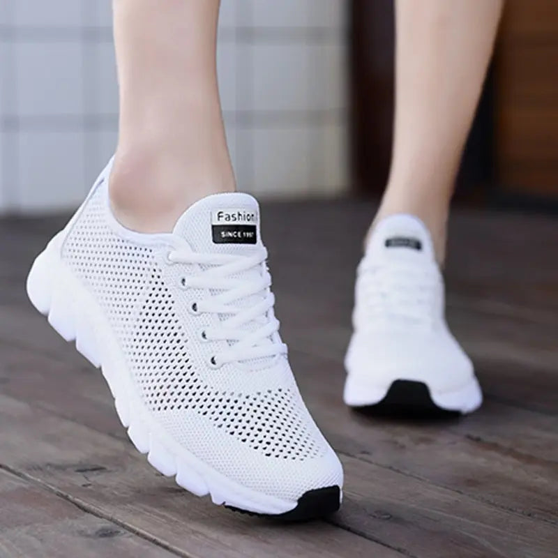 Women Mesh Sneakers – Lightweight Breathable Casual Shoes displayed on a wooden surface.