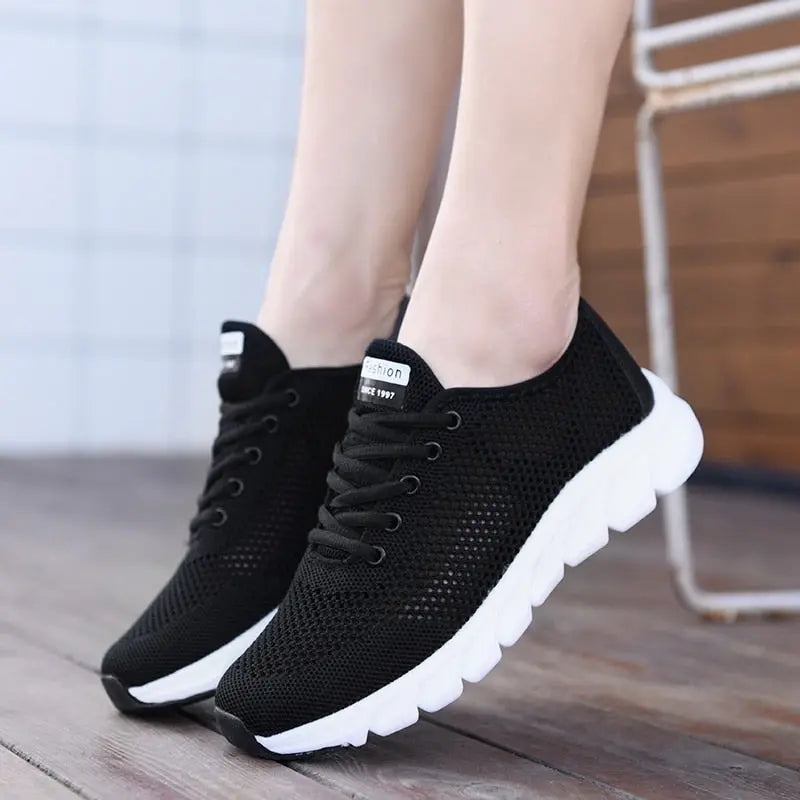 Women Mesh Sneakers in black, featuring lightweight breathable fabric and stylish non-slip sole for casual wear.
