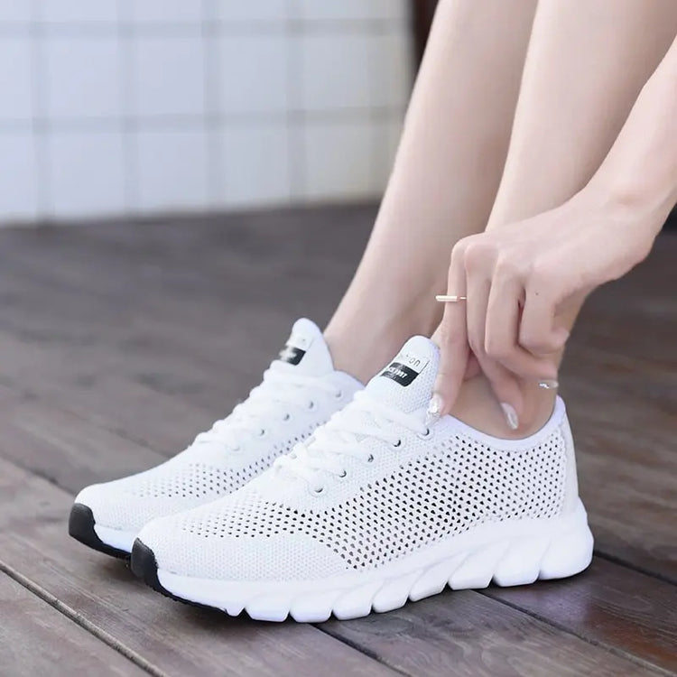 Women Mesh Sneakers – Lightweight Breathable Casual Shoes worn by a person sitting on a wooden floor.